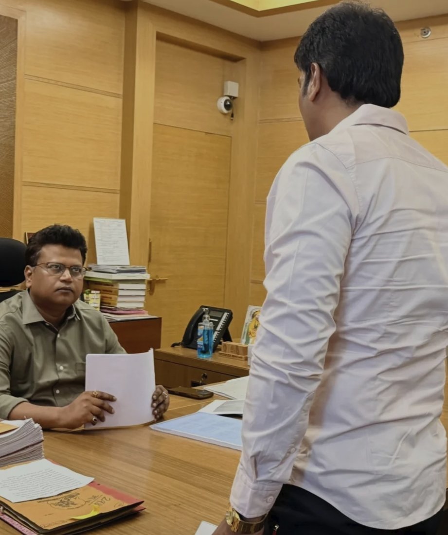 Reviewing ward planning files with a municipal official